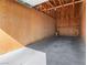 Spacious garage interior with concrete floor, plywood walls, and overhead door hardware at 3740 Desert Marina Dr # 7, Laughlin, NV 89029