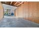 Unfinished garage interior showing plywood walls, concrete floor, and an open overhead door at 3740 Desert Marina Dr # 7, Laughlin, NV 89029