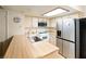 Traditional kitchen features white appliances, bright countertop, stainless steel sink, and a skylight at 3740 Desert Marina Dr # 7, Laughlin, NV 89029