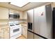 Bright kitchen with stainless steel refrigerator, white oven, and light cabinets, perfect for any home chef at 3740 Desert Marina Dr # 7, Laughlin, NV 89029