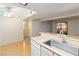 The bright kitchen features a stainless steel sink, dishwasher, and wood floors leading to the dining area at 3740 Desert Marina Dr # 7, Laughlin, NV 89029