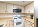 Traditional kitchen features a microwave, oven, and light wood countertops at 3740 Desert Marina Dr # 7, Laughlin, NV 89029