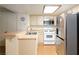 Bright kitchen with stainless steel appliances, tile floor, and breakfast bar into the living room at 3740 Desert Marina Dr # 7, Laughlin, NV 89029