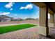 Well-maintained backyard with artificial grass, brick pavers, and a covered patio area at 3909 Grazing Gazelle Ave, North Las Vegas, NV 89084