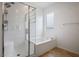 Modern bathroom boasting a glass-enclosed shower and a soaking tub, offering a luxurious retreat at 3909 Grazing Gazelle Ave, North Las Vegas, NV 89084