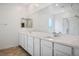 Bright bathroom featuring double sinks, a wide mirror, and a separate shower and bathtub at 3909 Grazing Gazelle Ave, North Las Vegas, NV 89084