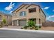 Charming two-story home featuring a 3-car garage, brick paver driveway, desert landscaping and an open air covered balcony at 3909 Grazing Gazelle Ave, North Las Vegas, NV 89084