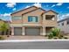 Charming two-story home featuring a 3-car garage, brick paver driveway, desert landscaping and an open air covered balcony at 3909 Grazing Gazelle Ave, North Las Vegas, NV 89084