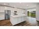 Contemporary kitchen featuring stainless steel appliances, white cabinets, a large island and seamless access to the backyard at 3909 Grazing Gazelle Ave, North Las Vegas, NV 89084