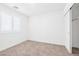 Cozy bedroom features carpet flooring, natural light from the window, and closet at 4125 Venus Falls Ave, North Las Vegas, NV 89084