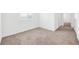 Bright and airy bedroom featuring soft carpeting and a view into the hallway at 4125 Venus Falls Ave, North Las Vegas, NV 89084