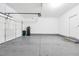 Large two car garage with epoxy flooring and side door leading to the yard at 4125 Venus Falls Ave, North Las Vegas, NV 89084