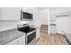 Modern kitchen features stainless steel appliances, granite countertops, and white cabinets at 4125 Venus Falls Ave, North Las Vegas, NV 89084