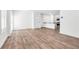 A bright and airy living room with wood-style flooring and crisp, white walls at 4125 Venus Falls Ave, North Las Vegas, NV 89084