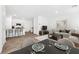 Bright, open-concept living room featuring a modern kitchen with an island and a cozy dining area at 4125 Venus Falls Ave, North Las Vegas, NV 89084