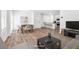 Open-concept living room featuring a dining area, kitchen with bar seating, and a comfortable seating arrangement at 4125 Venus Falls Ave, North Las Vegas, NV 89084