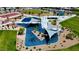 A community playground aerial view features modern play structures with sun shades, surrounded by trees at 4125 Venus Falls Ave, North Las Vegas, NV 89084