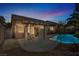 Inviting backyard featuring a covered patio, sparkling pool, and lush landscaping at 4443 Verdiccio Ave, Las Vegas, NV 89141