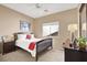 Comfortable bedroom with a bed, bedside tables, and a bright window at 4443 Verdiccio Ave, Las Vegas, NV 89141