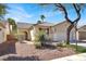 Inviting single-story home with desert landscaping, tile roof, and covered entryway enhancing its curb appeal at 4443 Verdiccio Ave, Las Vegas, NV 89141