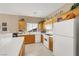 The kitchen features tile countertops, wooden cabinets, and bright white appliances at 4443 Verdiccio Ave, Las Vegas, NV 89141