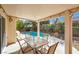 Covered patio with table and chairs overlooking the swimming pool and landscaped yard at 4443 Verdiccio Ave, Las Vegas, NV 89141