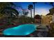 Sparkling pool with lush landscaping and a covered patio in this backyard oasis, perfect for relaxation and entertaining at 4443 Verdiccio Ave, Las Vegas, NV 89141