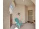 Cozy front porch with a decorative sun and turquoise chair creating a welcoming entryway at 4443 Verdiccio Ave, Las Vegas, NV 89141