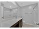 Bathroom with dark wood cabinets, white countertop, large mirror, and shower-tub combo at 502 Sonoma Range St, Las Vegas, NV 89138