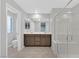 Bathroom with double sink vanity, large mirror, walk-in shower with bench, and separate toilet room at 502 Sonoma Range St, Las Vegas, NV 89138