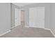 This is a simple bedroom with gray walls and carpet and a double door closet at 502 Sonoma Range St, Las Vegas, NV 89138