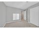 Bedroom with gray walls and carpet and window with blinds and an entry door at 502 Sonoma Range St, Las Vegas, NV 89138