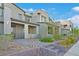 Contemporary townhome featuring drought-tolerant landscaping and paved walkway to the front entry at 502 Sonoma Range St, Las Vegas, NV 89138