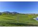 Lush green space with disc golf basket and picturesque mountain views on a clear, sunny day at 502 Sonoma Range St, Las Vegas, NV 89138