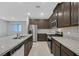 Spacious kitchen featuring granite counters, stainless appliances, and a central island sink at 502 Sonoma Range St, Las Vegas, NV 89138