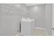 A laundry room with white washer and dryer machines and metal rack above at 502 Sonoma Range St, Las Vegas, NV 89138