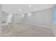 Spacious living room with neutral carpet, recessed lighting, and staircase access at 502 Sonoma Range St, Las Vegas, NV 89138