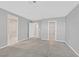 Large main bedroom featuring neutral walls, carpet, and multiple doorways and closets at 502 Sonoma Range St, Las Vegas, NV 89138
