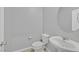 Clean powder room featuring a pedestal sink, modern fixtures, and a toilet at 502 Sonoma Range St, Las Vegas, NV 89138