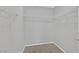 Walk-in closet featuring neutral walls, carpet, and multiple levels of metal storage racks at 502 Sonoma Range St, Las Vegas, NV 89138