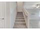 A carpeted staircase leading to the upper level, blending functionality with the home's neutral color scheme at 534 Lassen Falls Ct, Henderson, NV 89044