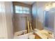 Bathroom in process of being updated, featuring new tiling, a window, and updated sink at 5517 Rose Thicket St, Las Vegas, NV 89130
