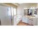 Bright bathroom featuring a double sink vanity, bathtub, and shower at 5517 Rose Thicket St, Las Vegas, NV 89130