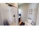 Bathroom featuring a walk-in shower with white tiling and a modern vanity at 5517 Rose Thicket St, Las Vegas, NV 89130