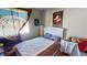 Bedroom featuring a window with wall hanging and a light colored bedspread at 5517 Rose Thicket St, Las Vegas, NV 89130