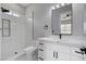 Bathroom featuring a white vanity with black fixtures, marble countertops, and a walk-in shower at 5601 Mary Lou St, Pahrump, NV 89061