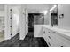 Sleek bathroom boasting double vanity, and black tile walk-in shower with a glass door, and modern fixtures at 5601 Mary Lou St, Pahrump, NV 89061