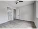 Bedroom featuring wood-look floors, closet, ensuite bathroom, and neutral gray paint at 5601 Mary Lou St, Pahrump, NV 89061
