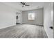 Bright bedroom with a ceiling fan, large window, and sleek flooring, providing a comfortable retreat at 5601 Mary Lou St, Pahrump, NV 89061