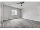 Spacious bedroom with a large window, ceiling fan, and neutral tones, creating a relaxing atmosphere at 5601 Mary Lou St, Pahrump, NV 89061